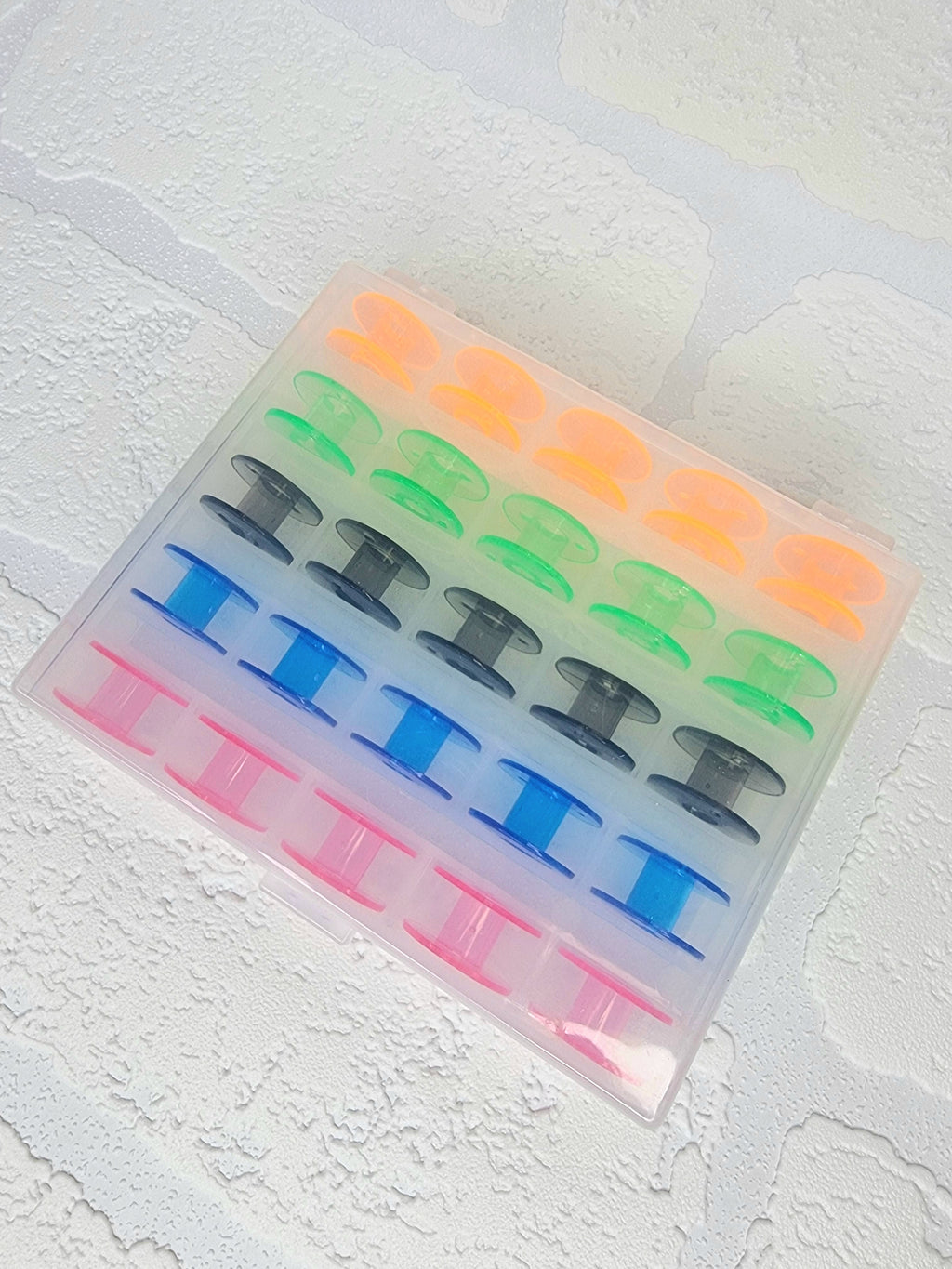 25 x colourful bobbins in storage box/organiser