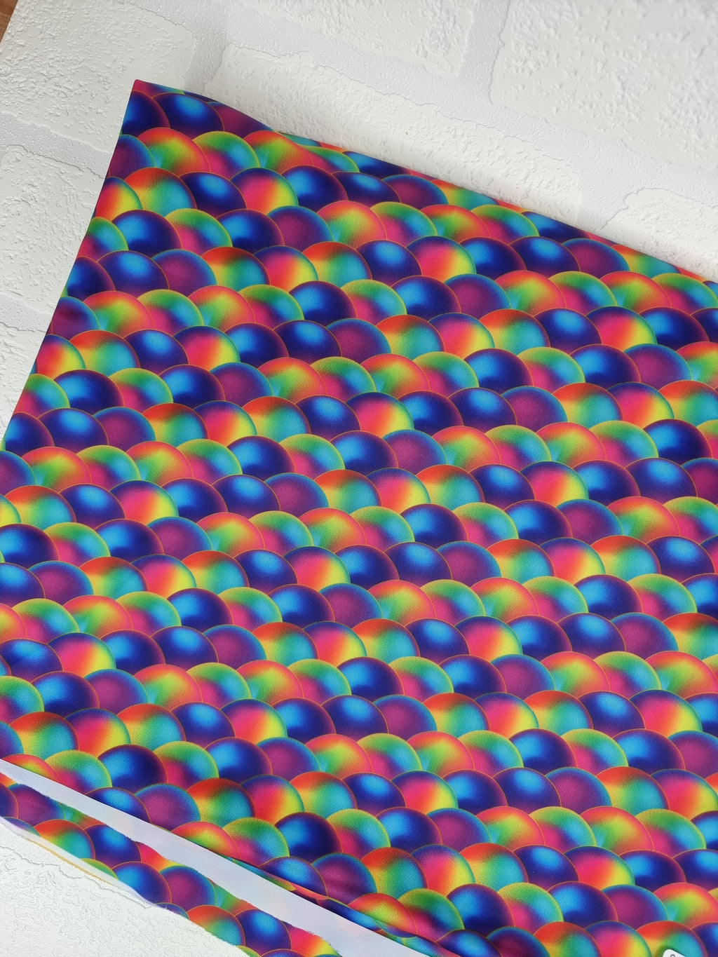 Rainbow multicoloured scales digitally printed onto swim UV50+ fabric