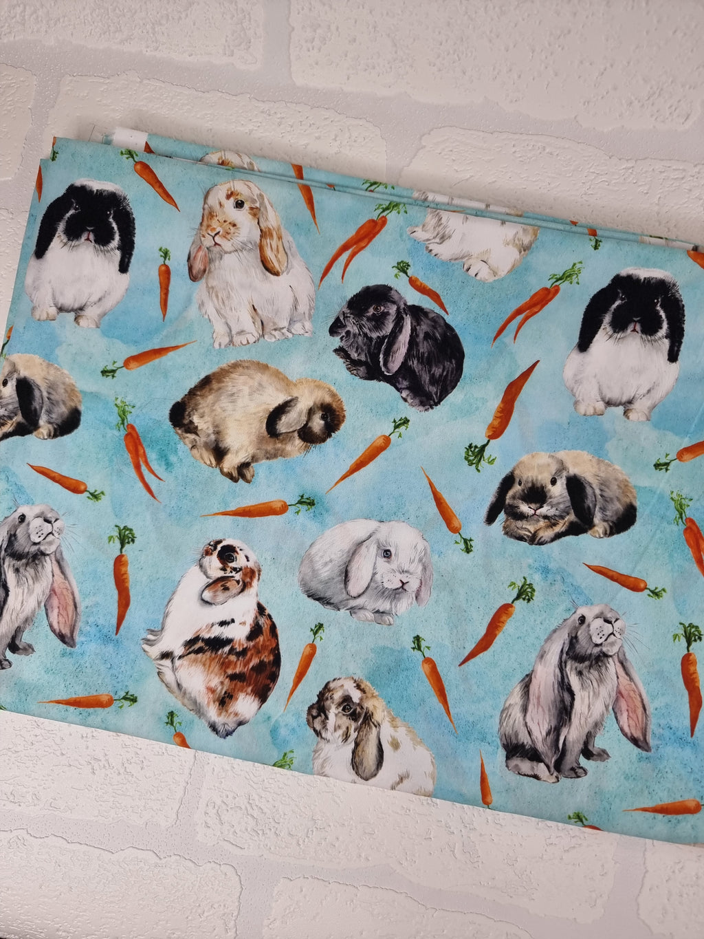 Adorable realistic rabbit breeds on a cloudy blue background. Digitally printed onto cotton poplin