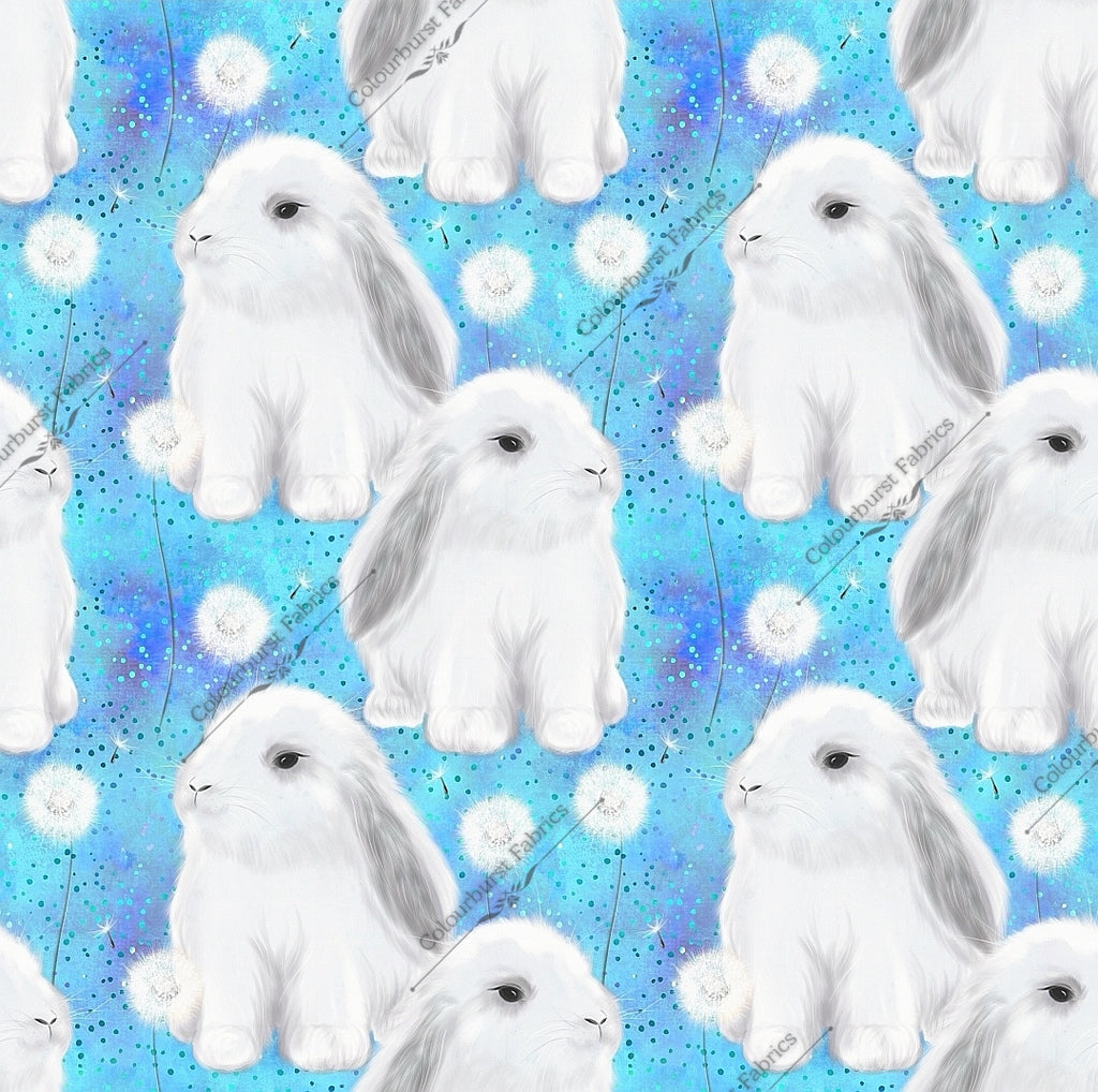 Cute fluffy white bunnies with grey markings on a light blue background with dandelions. Exclusive design for custom fabric printing onto our 22 bases