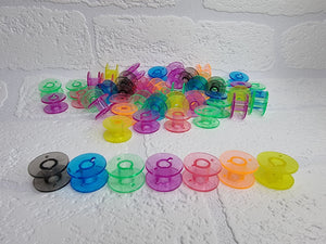 Rainbow bright coloured bobbin colours. Clear plastic, universal fit. Orange, pink, yellow, red, purple, green, blue and black bobbin