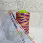 Load image into Gallery viewer, Rainbow thread spools, beautiful shades of the rainbow on the one thread. 3000 yards per cone, suitable for all sewing.
