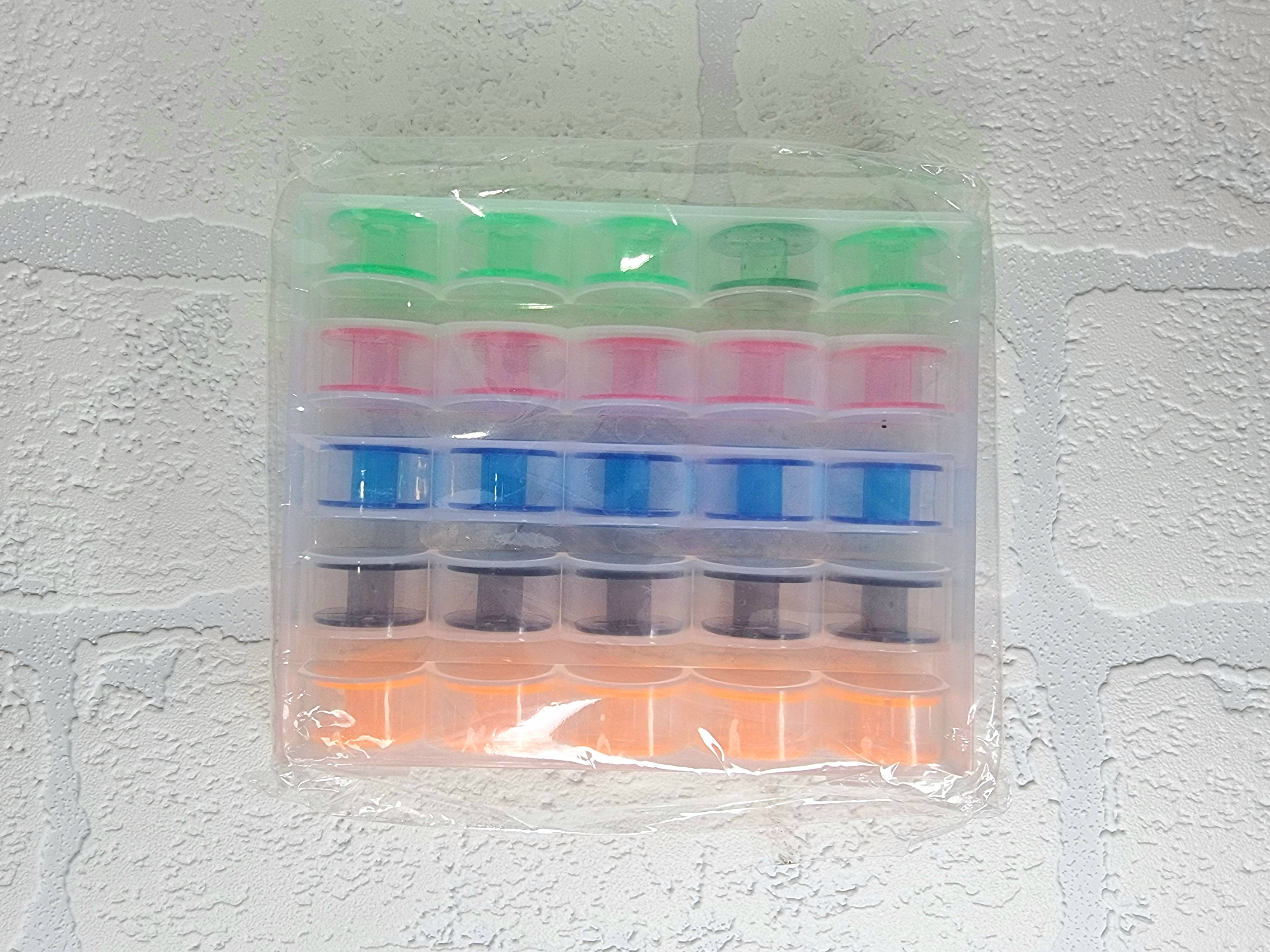 25 x colourful bobbins in storage box/organiser