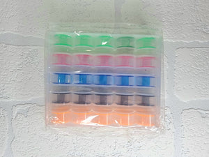 25 x colourful bobbins in storage box/organiser