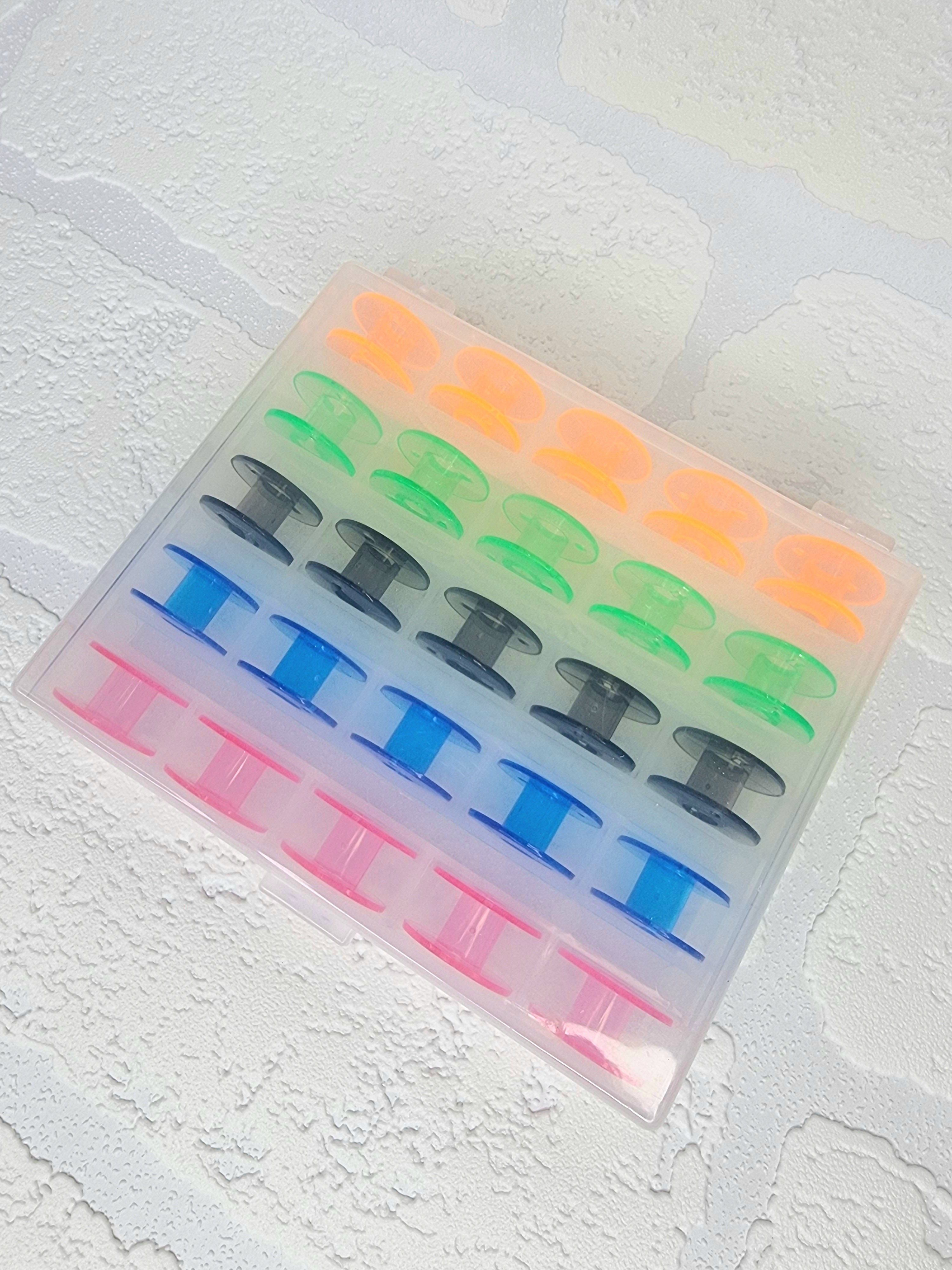 25 x colourful bobbins in storage box/organiser
