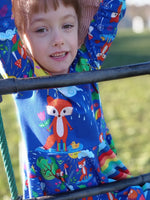 Load image into Gallery viewer, Beautiful dress made to show off our adorable fox design, modelled by a beautiful little one at the park. Picture shows Adorable foxes in cute habitats, one with unbrella under rain cloud, one sleeping on tree stump, one soaking up the rain and one standing under the sun. Exclusive design for pre-order at Colourburst Fabrics 
