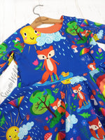 Load image into Gallery viewer, Beautiful dress made to show off our adorable fox design. Picture shows Adorable foxes in cute habitats, one with unbrella under rain cloud, one sleeping on tree stump, one soaking up the rain and one standing under the sun. Exclusive design for pre-order at Colourburst Fabrics 
